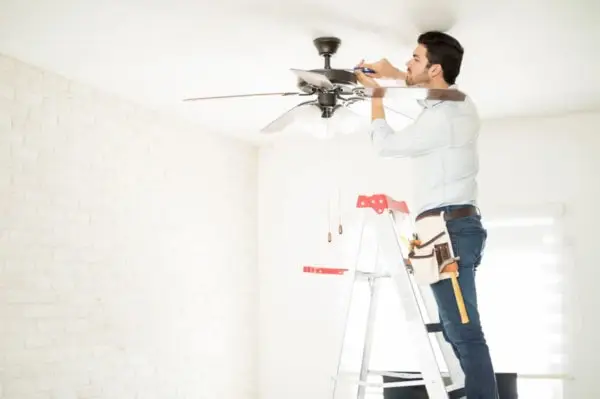 man fixing ceiling fan
