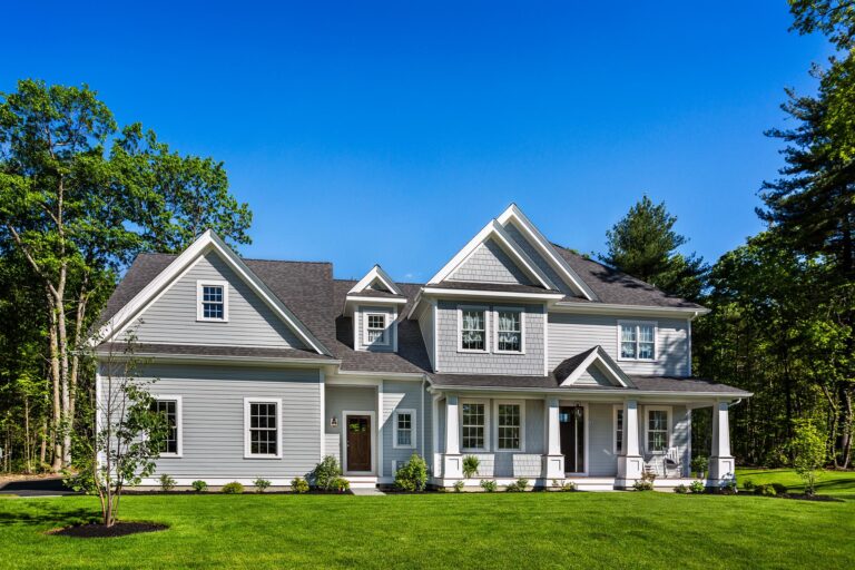 Energy-efficient vinyl siding in Ipswich MA on a modern gray craftsman home by Coastal Windows & Exteriors