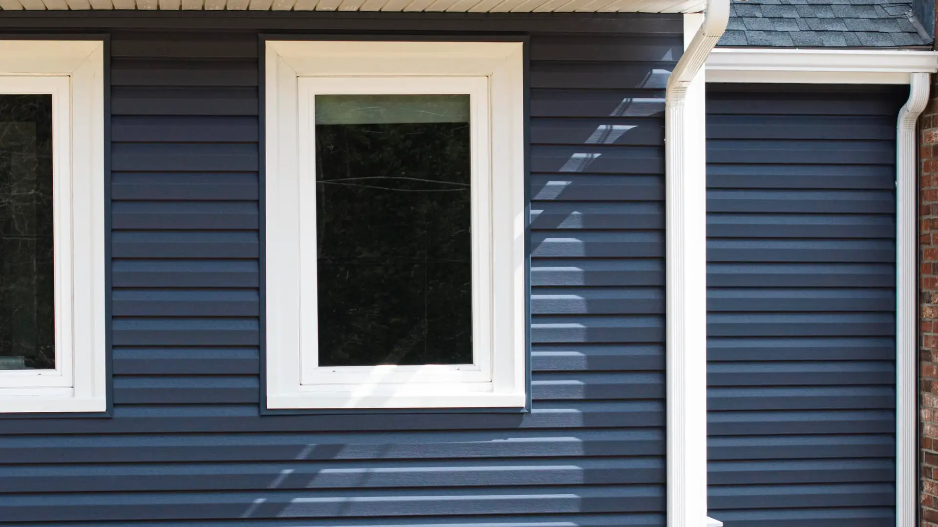 blue vinyl siding and window installation by Coastal Windows & Exteriors