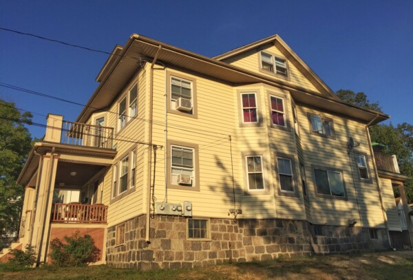 Lifetime vinyl siding installed on a historic Quincy MA home to replace aging wood shingles and eliminate repainting