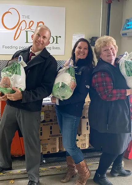 Stacks of insulated Thanksgiving food bags and turkeys donated by Coastal Windows & Exteriors at Henry’s Market in Beverly