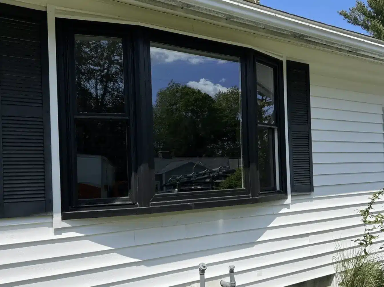 Contemporary home exterior with large sliding glass windows and minimalist frames highlighting modern window design trends