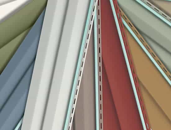 Abstract composition of overlapping metal panels in various colors, including green, white, gray, red, and brown, with perforated edges. The panels are arranged in a fan-like pattern forming dynamic diagonal lines.