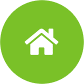 A white house icon with a triangular roof and chimney on a green circular background.