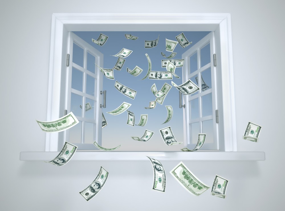 US dollar bills are flying out of an open window into the sky, symbolizing money being lost or wasted. The scene reminds you to check your windows for air leakage, as it can lead to higher energy costs slipping away.