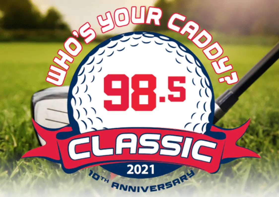 A golf-themed logo with Who’s Your Caddy? in red above a golf ball showing Classic 98.5 in bold, CLASSIC in blue on a red banner, and 2021 Anniversary Event below; a golf club and grass in the background.