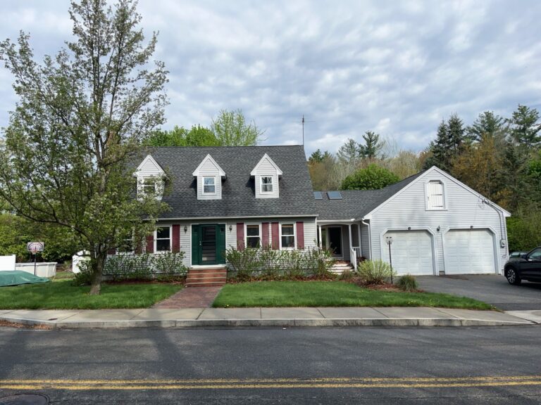 Customer testimonial saying “We couldn’t be happier…” with roof visible above house. Roofing in Leominster MA. Roofing in Leominster MA