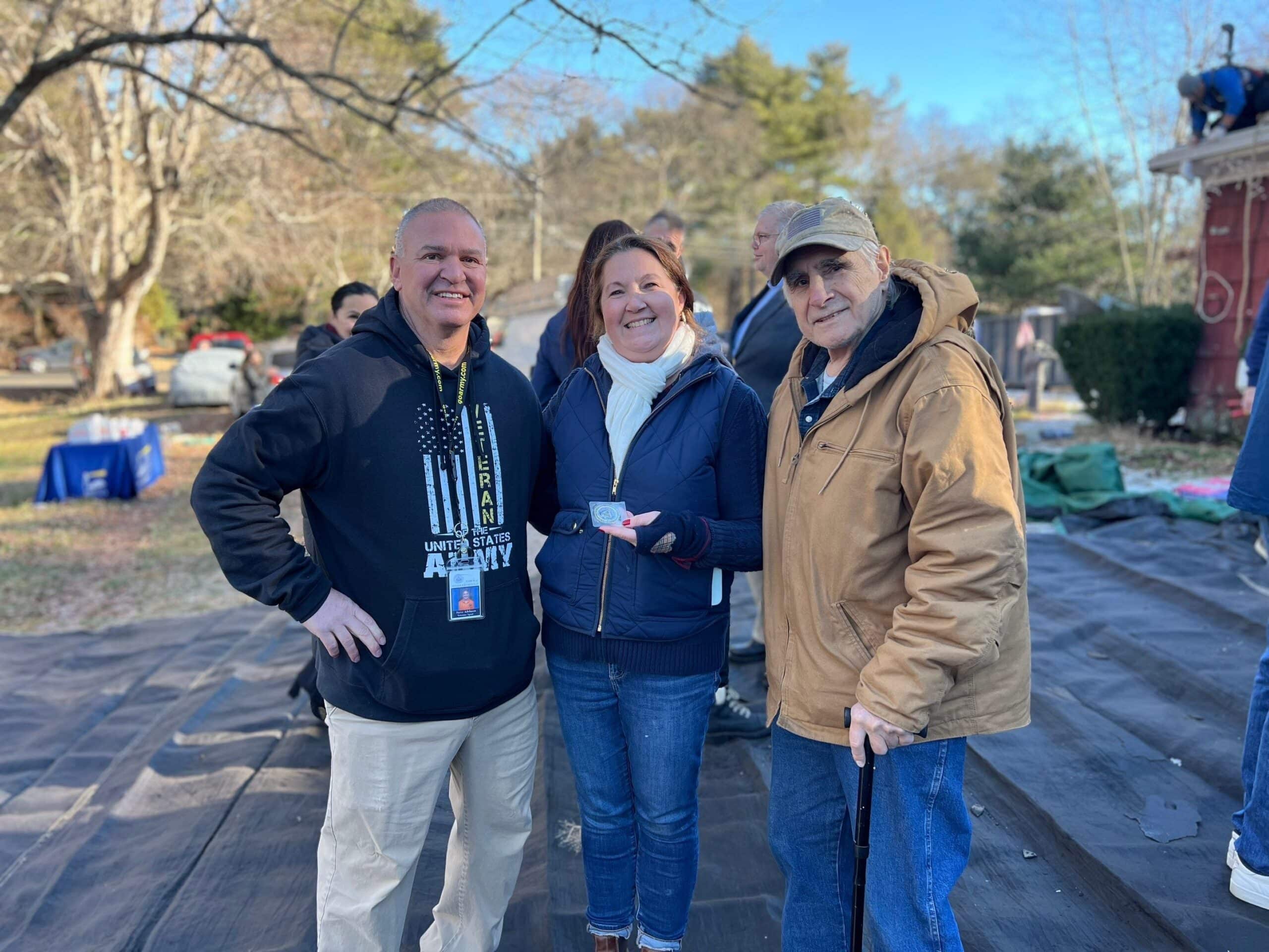 Coastal Windows & Exteriors team celebrates a Roof For Heroes project completion in Natick MA.