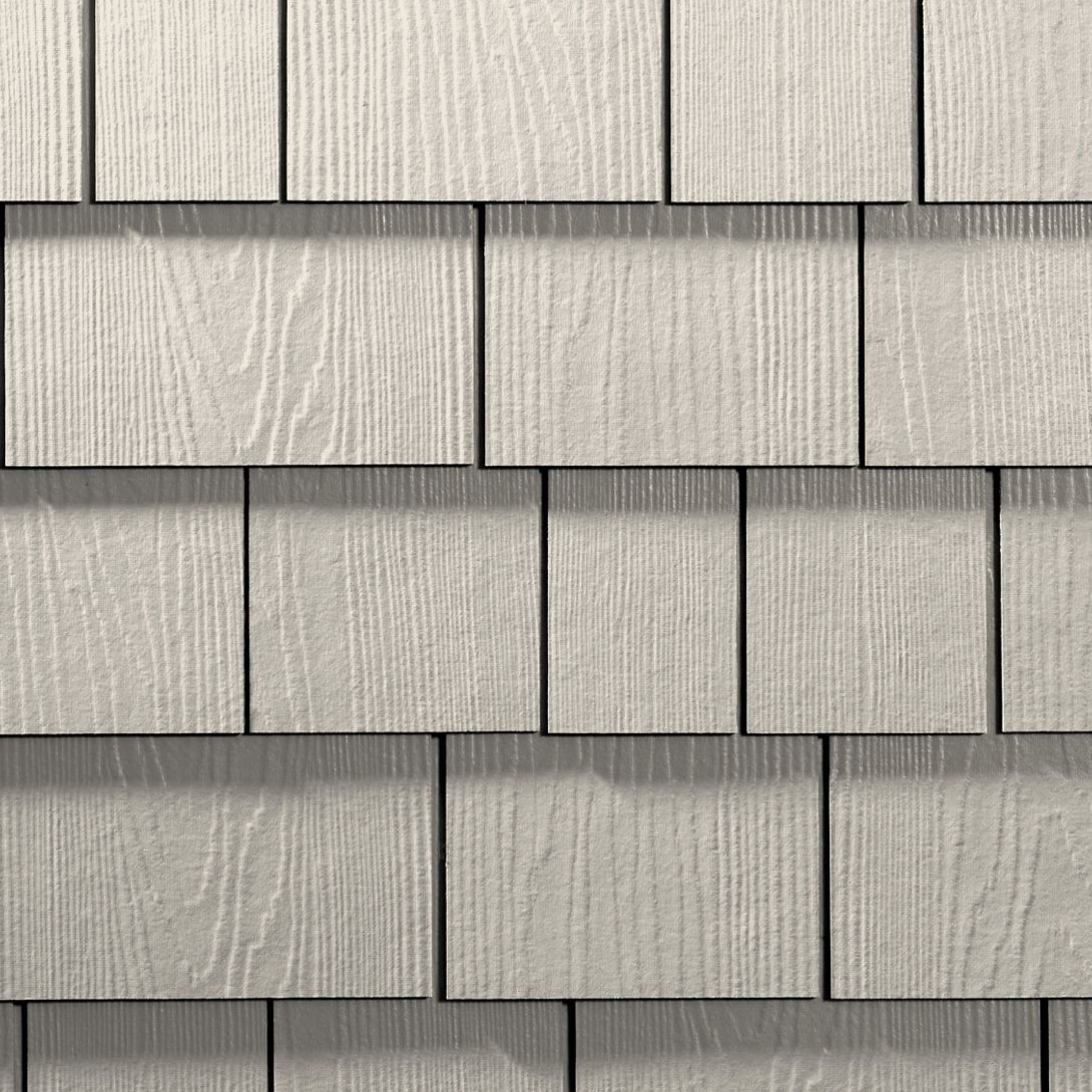 Close-up of shingle siding texture included in roofing faq about exterior materials.